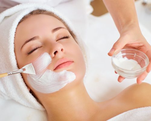 Woman in mask on face in spa beauty salon.