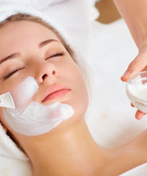 Woman in mask on face in spa beauty salon.